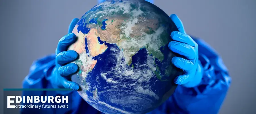 Gloved hands holding planet earth