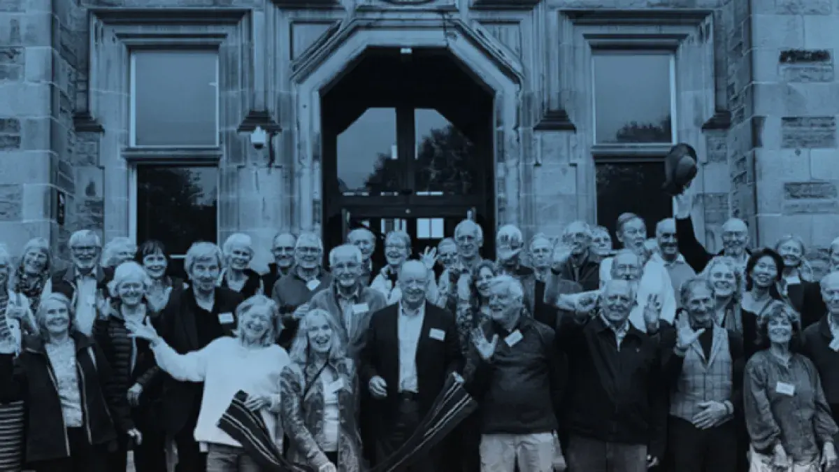 Group photo of the MBChB Class of 1974 standing on the steps of the Edinburgh Futures Institute