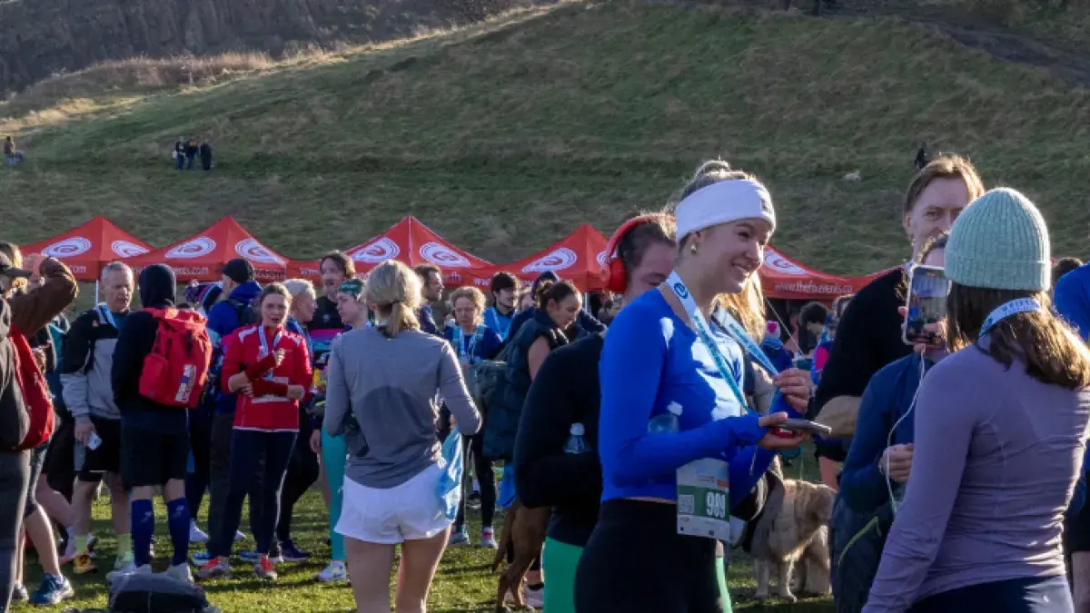 Runners and spectators in Holyrood Park following the 2025 Winter Warmer run.
