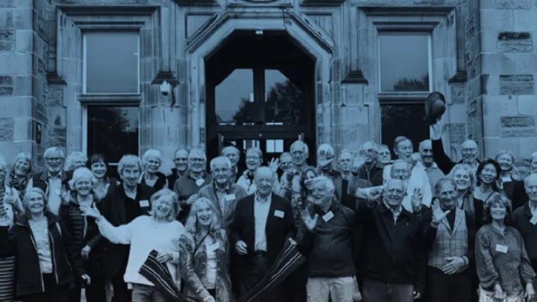 Group photo of the MBChB Class of 1974 standing on the steps of the Edinburgh Futures Institute