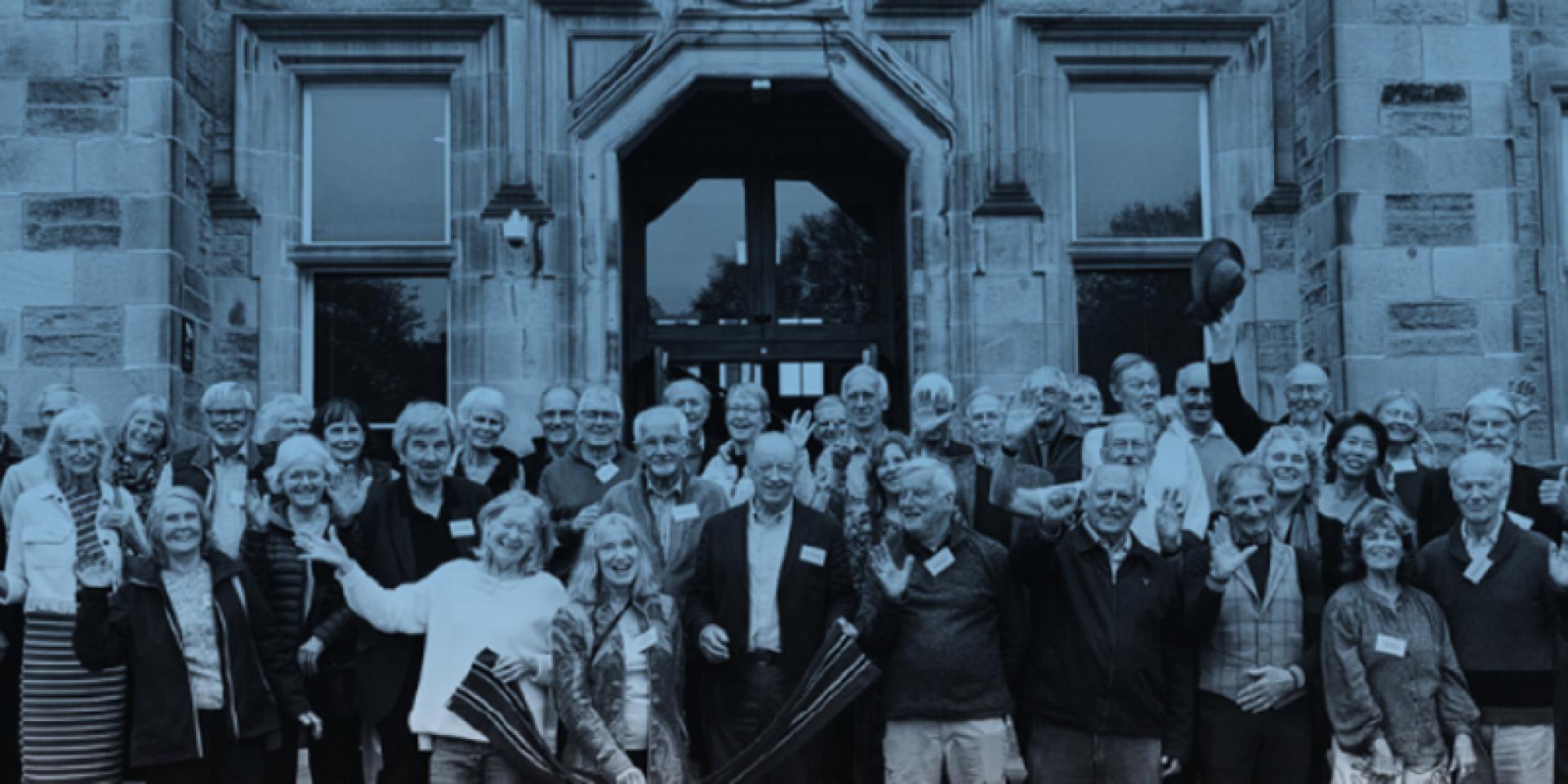 Group photo of the MBChB Class of 1974 standing on the steps of the Edinburgh Futures Institute