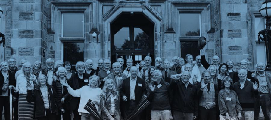 Group photo of the MBChB Class of 1974 standing on the steps of the Edinburgh Futures Institute