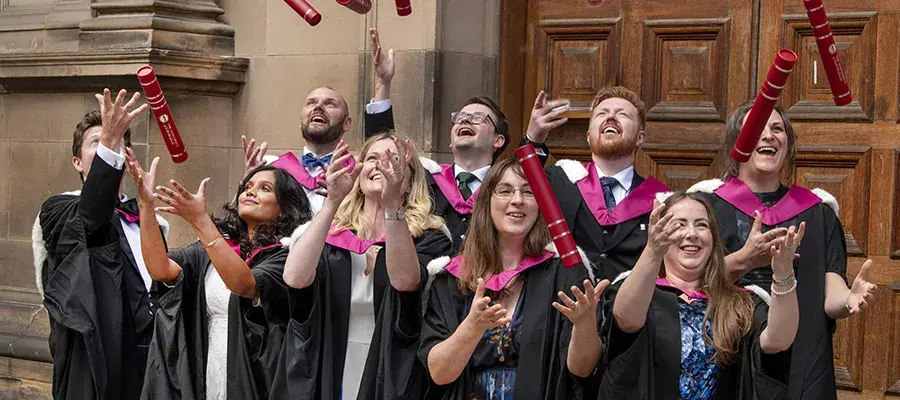 HCP Med students in graduation robes outside McEwan Hall