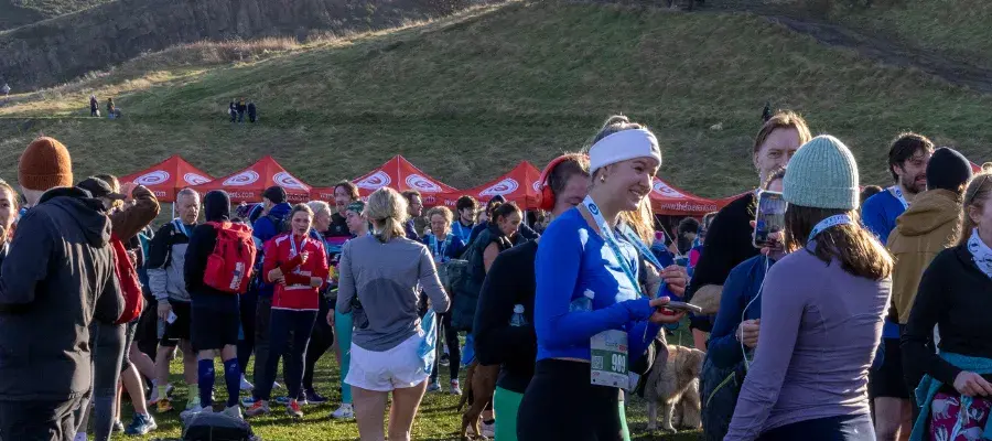 Runners and spectators in Holyrood Park following the 2025 Winter Warmer run.