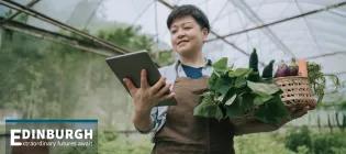 Scientist with produce in a greenhouse