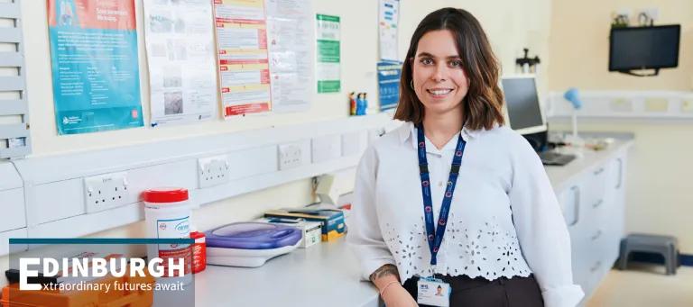 Health scientist standing in a medical setting.