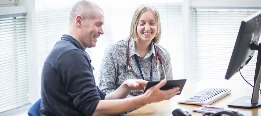 Colleagues viewing information on an Ipad