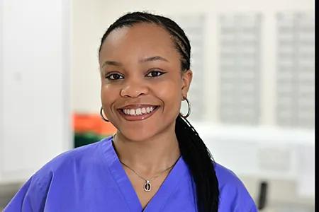 Head shot of Ebo, smiling at camera