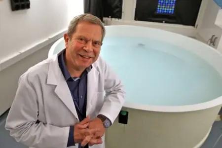 Image of Richard Morris in front of water maze 