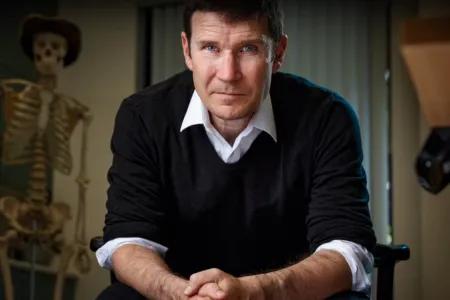 Moody portrait of Gavin with skeletons in the background