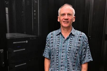 Mid shot of John with dark background