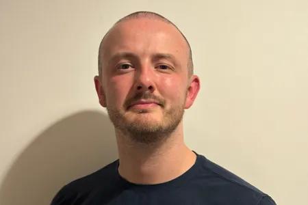 Head shot of Robert against plain backdrop