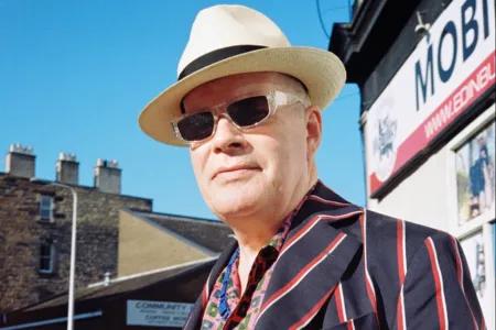 Headshot of Robert Wylie wearing a hat and sunglasses
