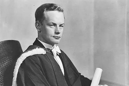 Murray in graduation gown. Black and white.