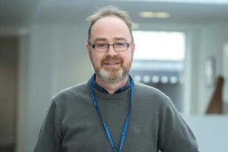 Head shot of Chris against office background