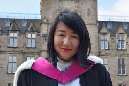 Nataysia wearing graduation robes