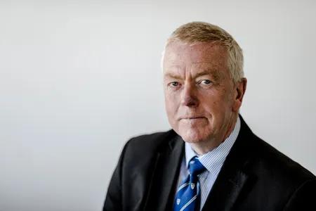 Portrait of John against neutral background