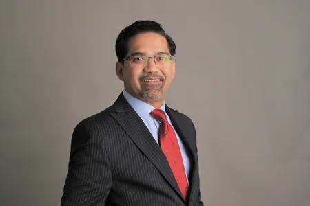 Portrait of Amrit against neutral background