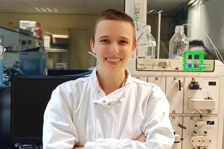 Audrey, smiling, in a lab setting