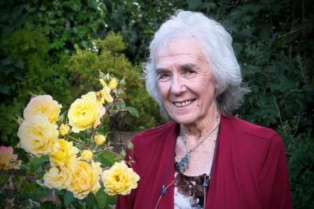 Portrait of Eve in the garden with yellow flowers in the background