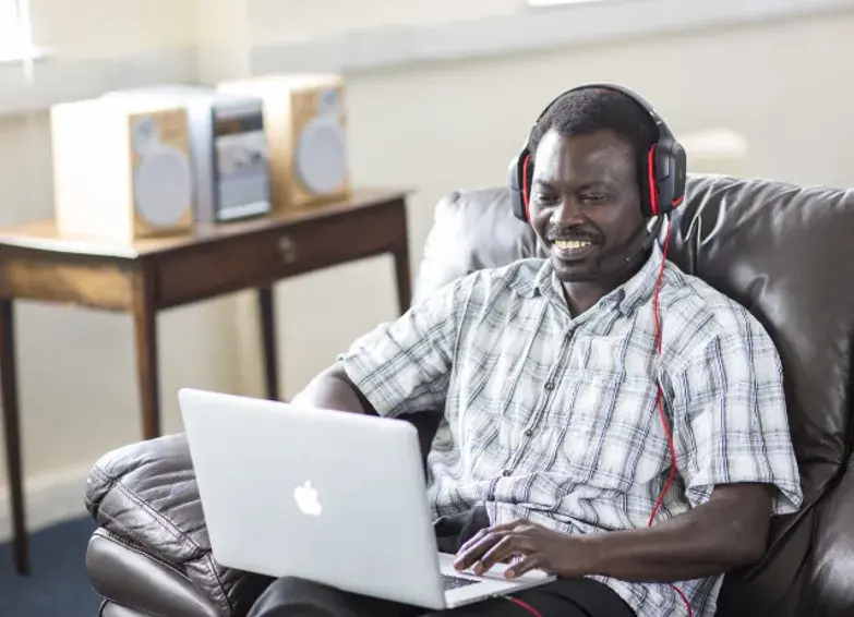 online student studying at home with headphones on