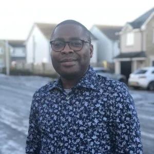 Portrait of Oluseye Ogunbayo with city street in background