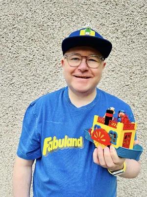 Shot of Stewart holding up a Lego toy