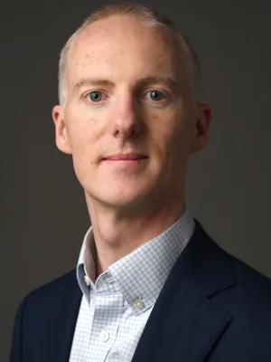 Portrait of Mathew against dark background