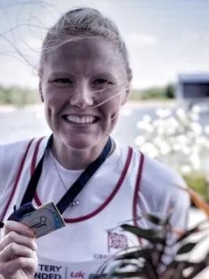 Polly shows an Olympic medal for the camera