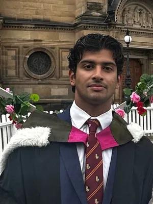 Portrait of Huzefah Hanif wearing graduation robes