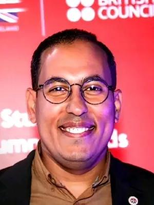 Portrait of Mohamed Elsonbaty Ramadan against vivid red background