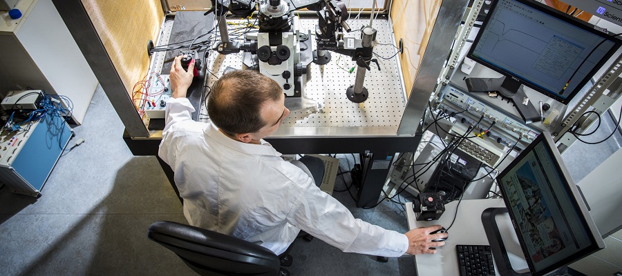 Man seated in lab with equipment