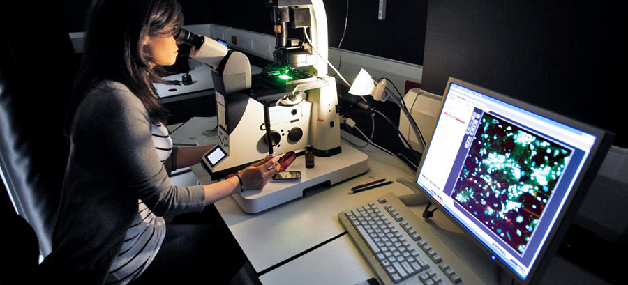 Woman looking into microscope