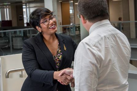 Woman and man shaking hands