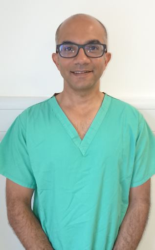 CJ Shukla in surgical scrubs