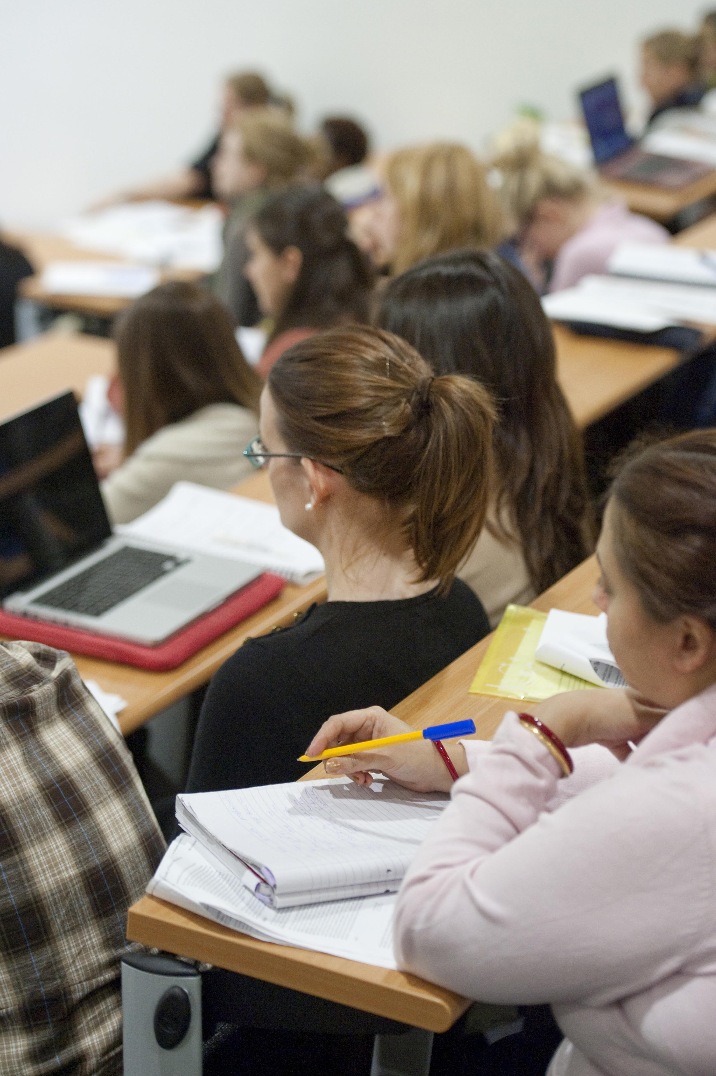 students in lecture theatre listening to tutor