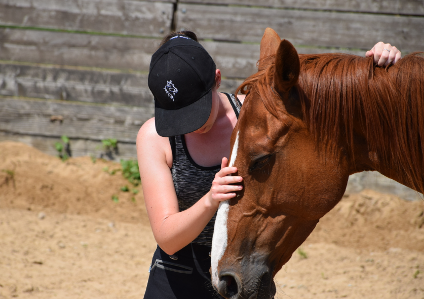 Nadia stroking a horse