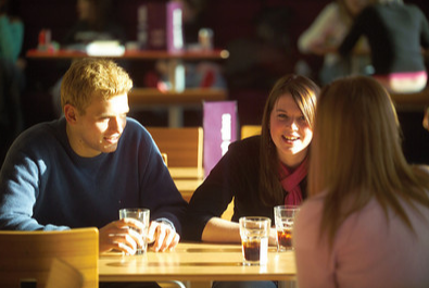 group of postgrads chatting in cafe