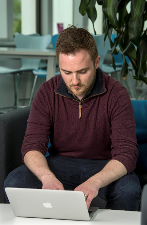 phd student tim wilkinson on his laptop